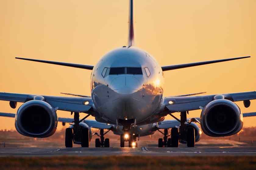 Airplane-airport-runway-against-clear-sky-sunset - travel and tour world