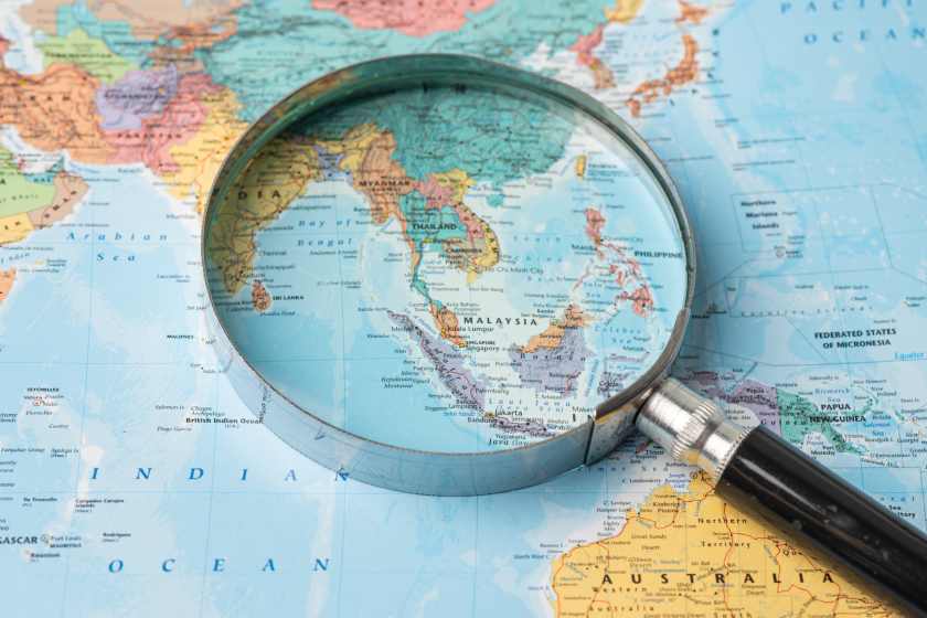 Asia-magnifying-glass-close-up-with-colorful-world-map - travel and tour world