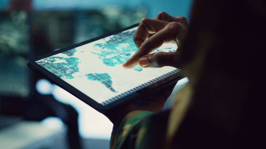 Military-it-professional-gathers-intelligence-from-world-map-projection - travel and tour world