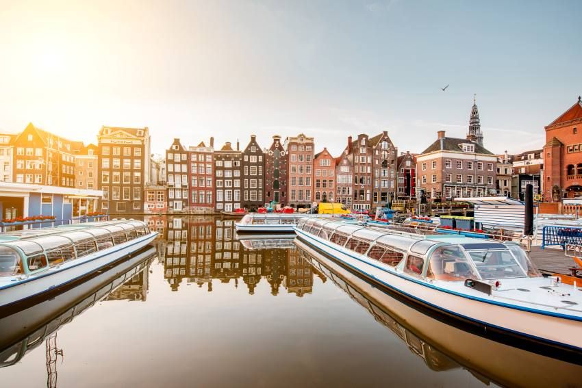 Morning-view-beautiful-buildings-boats-damrak-avenue-amsterdam - travel and tour world
