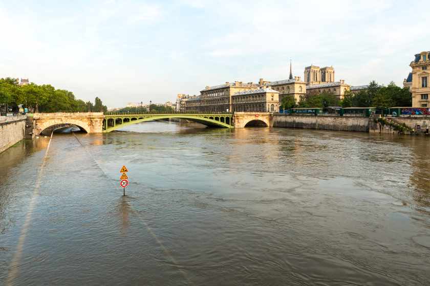 Notre-dame-de-paris-by-bridge-river-against-sky-city - travel and tour world