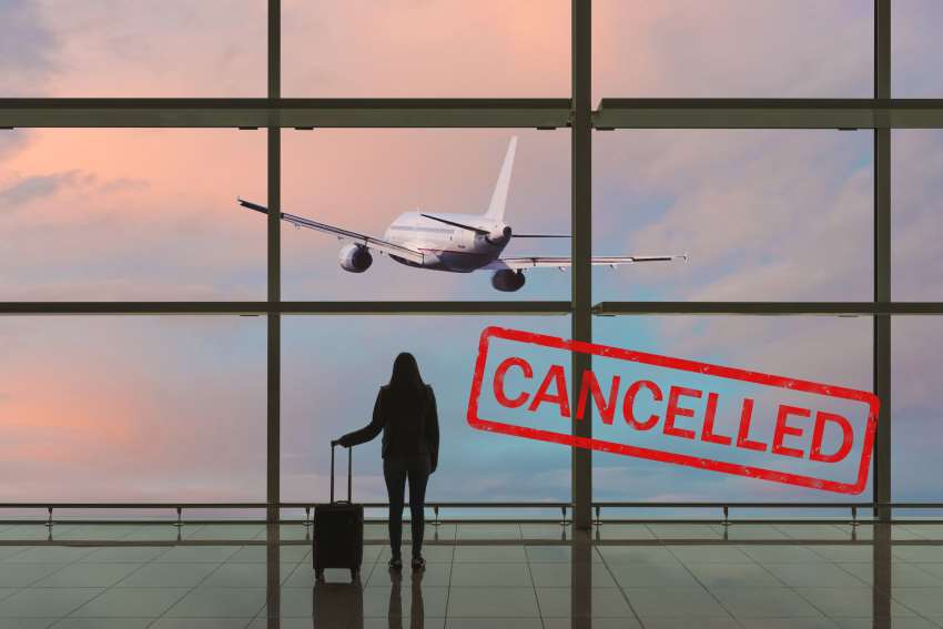 Young-woman-with-suitcase-departure-hall-airport - travel and tour world