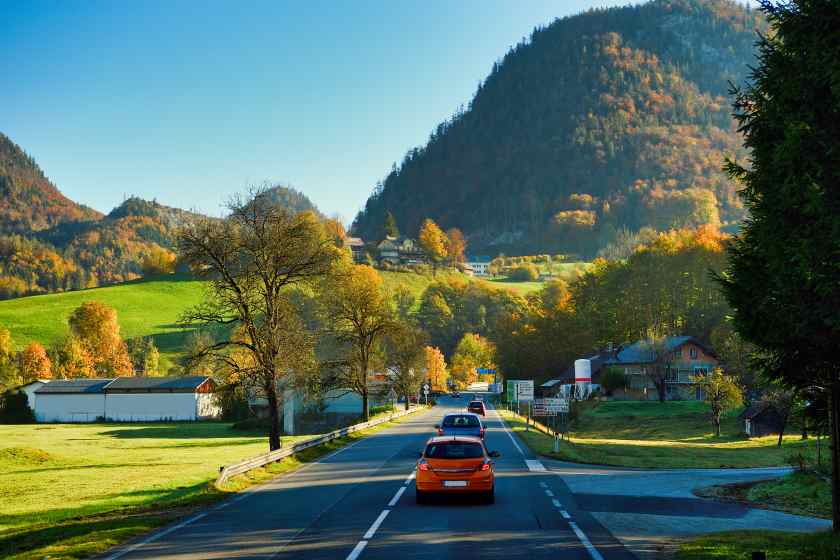 Cars-road-by-trees-against-sky-autumn - travel and tour world
