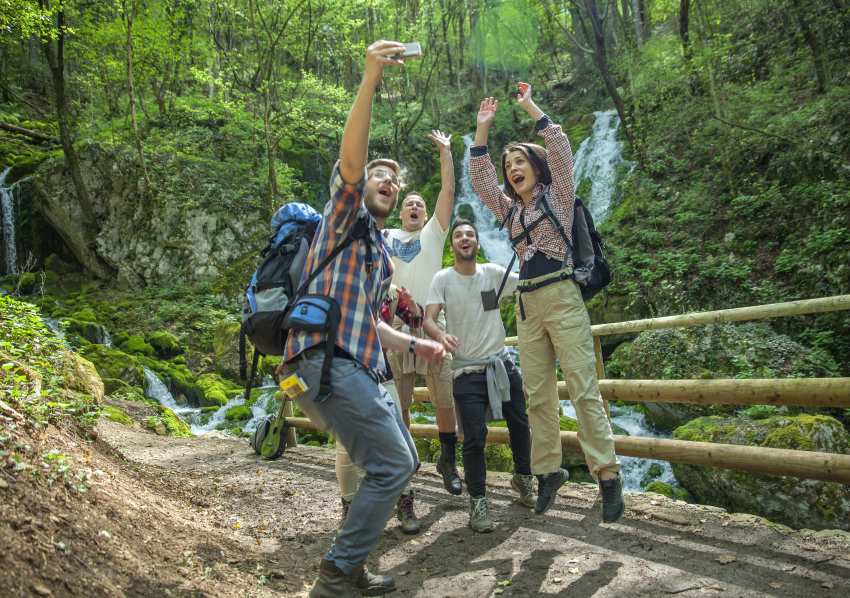 Group-friends-having-fun-taking-selfies-nature - travel and tour world
