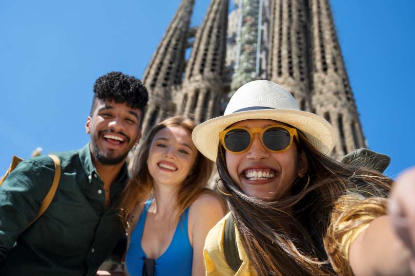 Low-angle-happy-friends-posing - travel and tour world