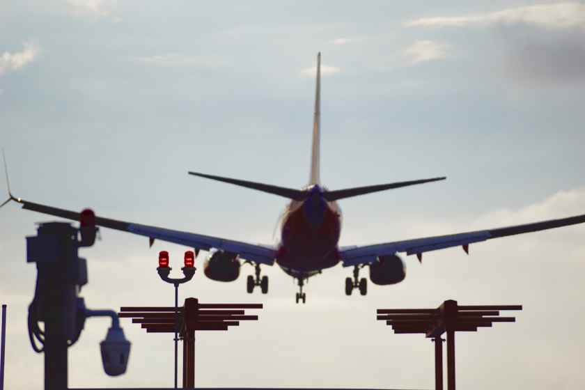Low-angle-view-airplane-flying-against-sky - travel and tour world