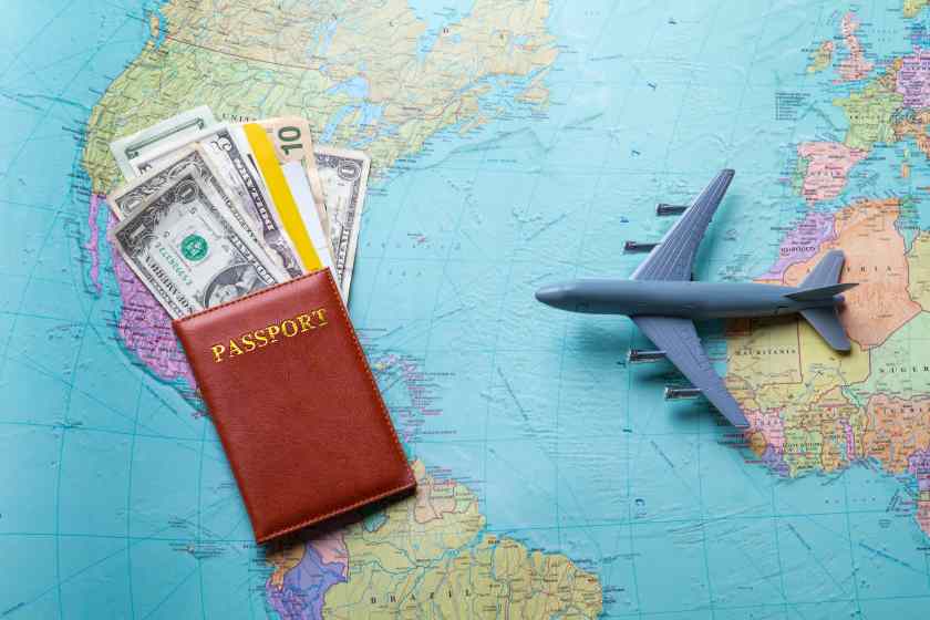 Passport-toy-plane-map-with-passport-money-choose-best-destination-fly-across-ocean - travel and tour world