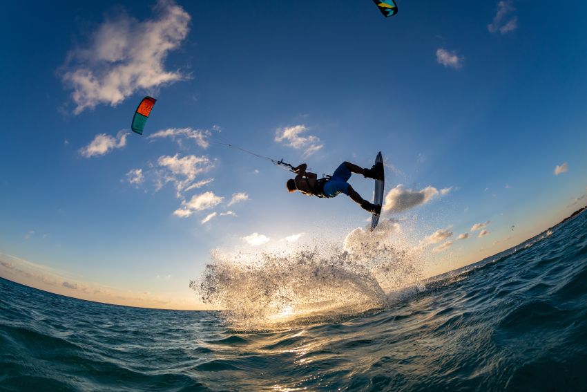 Person-surfing-flying-parachute-same-time-kitesurfing-bonaire-caribbean - travel and tour world