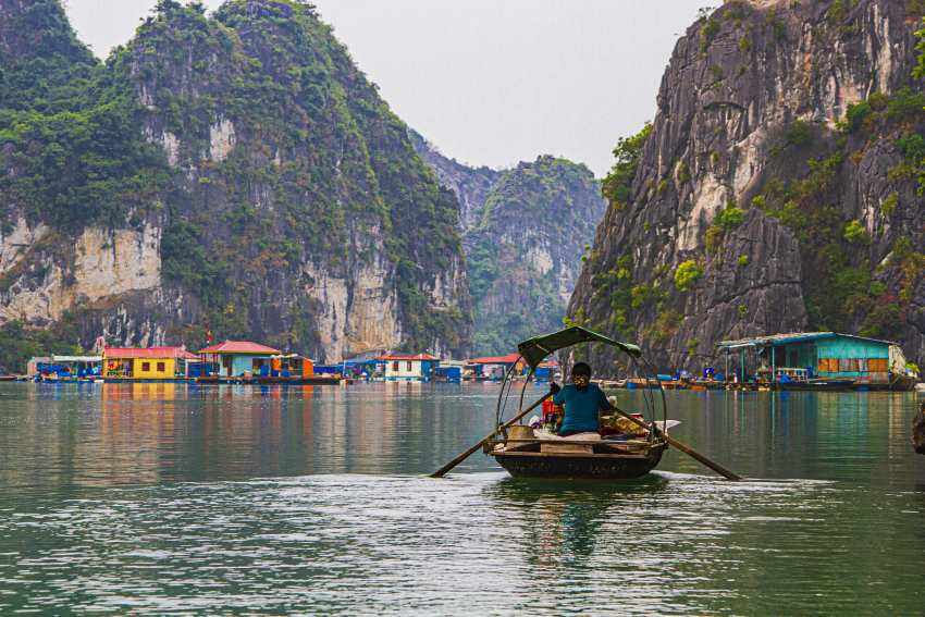 Vietnam's scenic bay with limestone karsts and floating villages. - travel and tour world Vietnam scenic bay with limestone cliffs and floating villages.