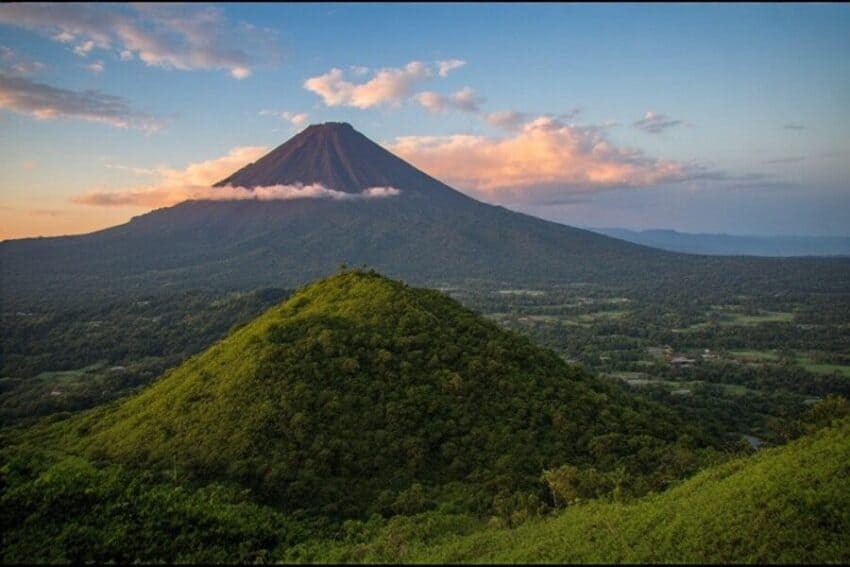 Costa rica volcano and green landscape - travel and tour world Volcano and lush green landscape in costa rica promoting sustainable tourism.