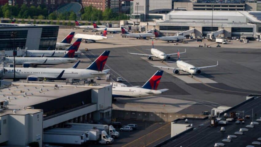 Delta airlines planes parked at an airport terminal.