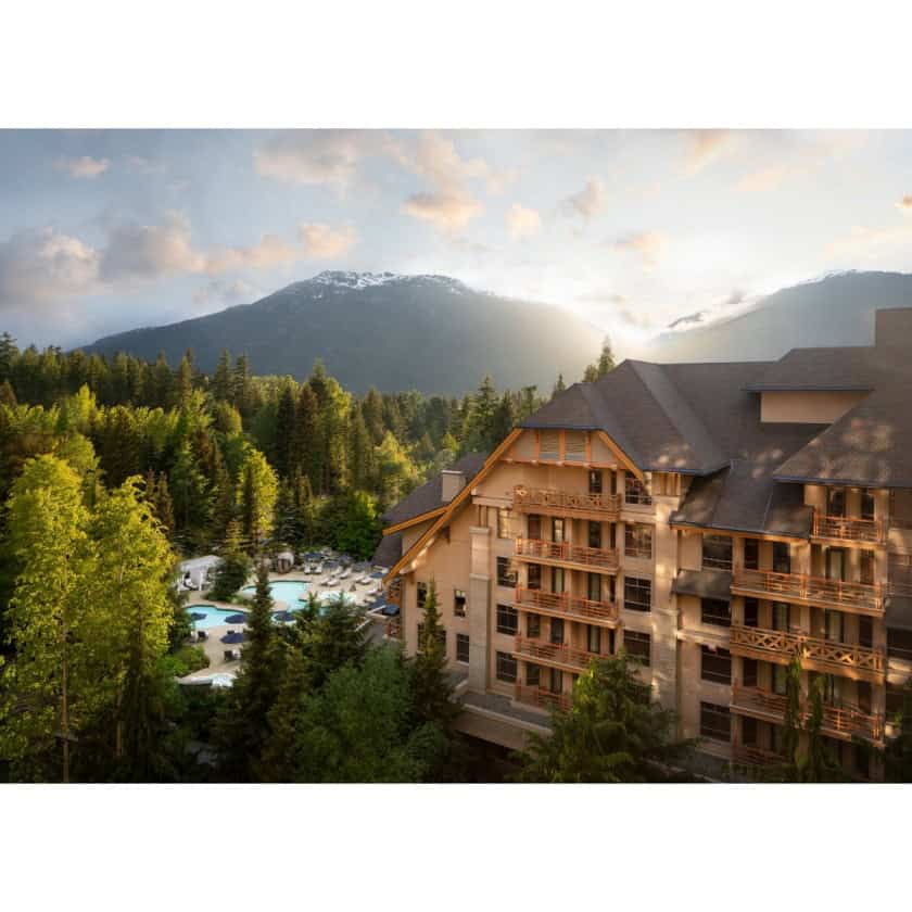 Luxury mountain resort surrounded by lush forest and scenic mountain views.