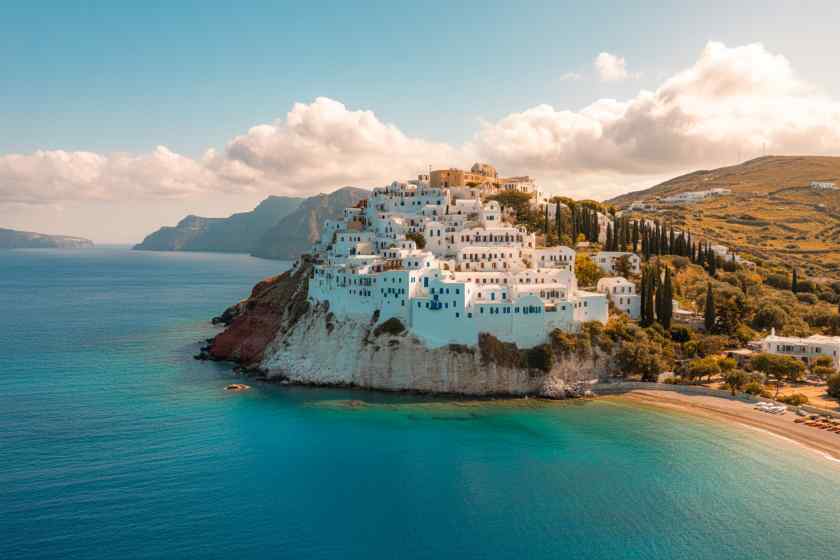 Travel and tour world - travel and tour world Scenic view of santorini's white buildings and blue waters in Greece.