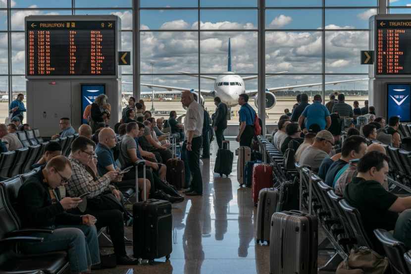 Passengers waiting at philadelphia airport during flight cancellations and delays.