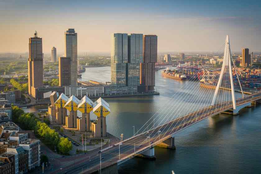 Rotterdam - travel and tour world Modern city skyline with skyscrapers and a cable-stayed bridge over a river in r.