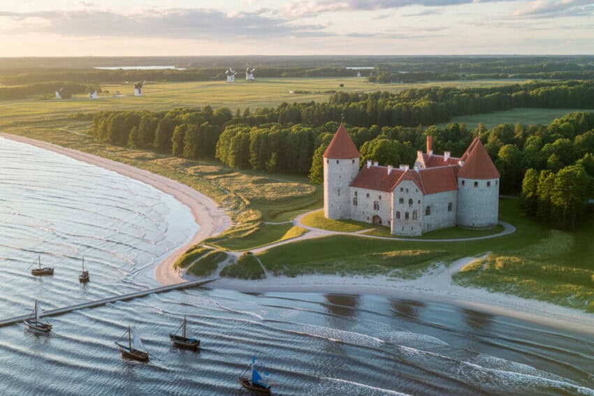 Historic saaremaa castle with tranquil baltic sea views and lush greenery.