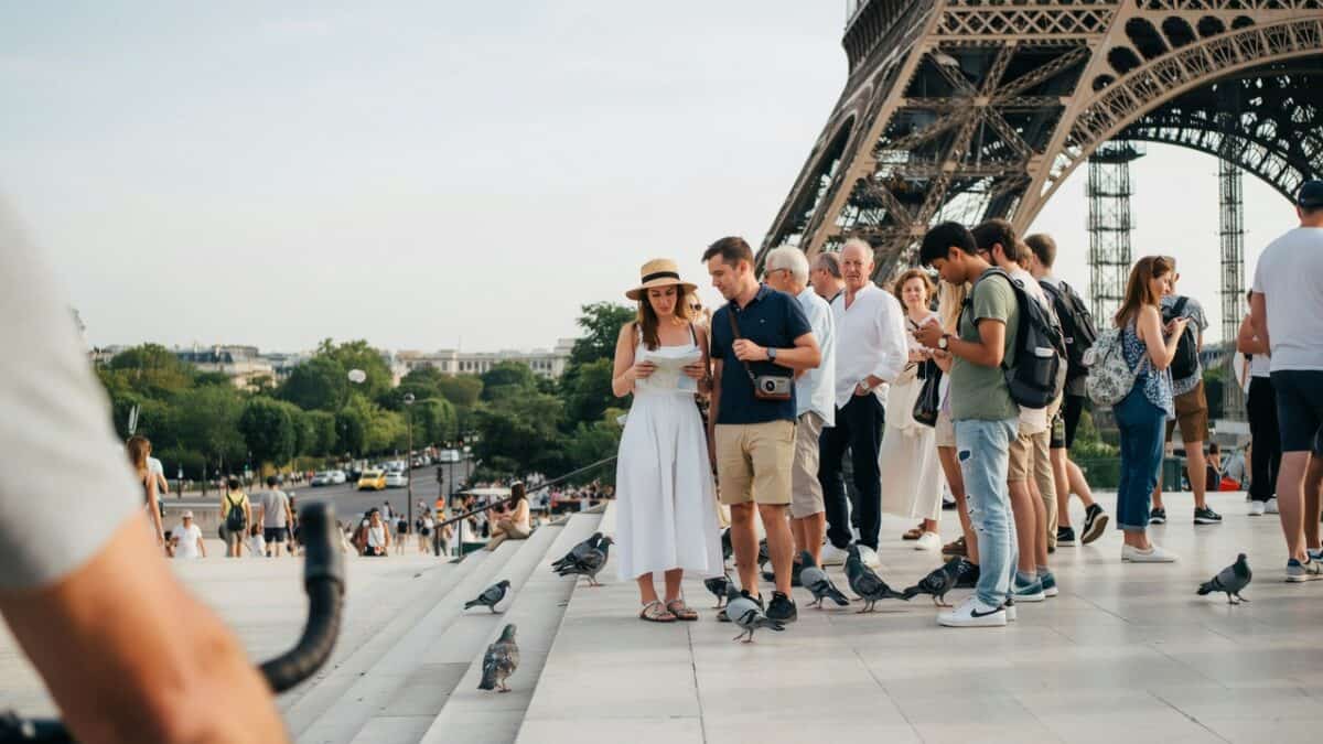 Tourists and pigeons near the eiffel tower in paris, france.