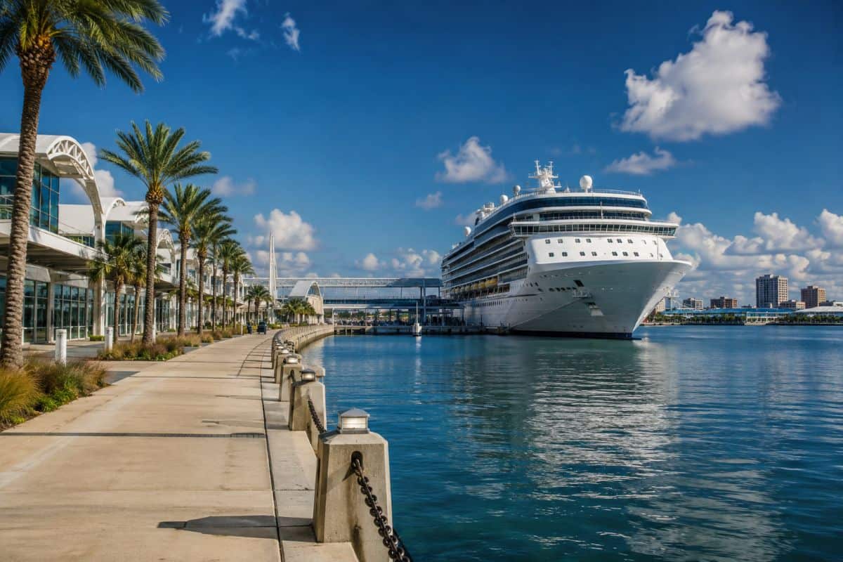 A beautiful texas cruise port with a luxury ship, palm-lined promenade, calm blue waters, and bright coastal skies.