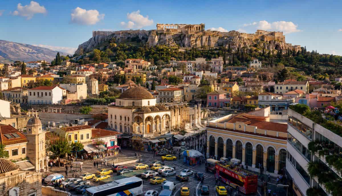 Athens cityscape showcases the acropolis above colourful neighbourhoods busy roads taxis buses and lively mediterranean urban energy