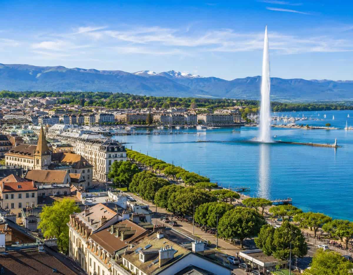 Geneva cityscape showcasing lake geneva jet deau fountain historic buildings lush greenery - travel and tour world Geneva cityscape showcasing lake geneva, jet d’eau fountain, historic buildings, lush greenery,