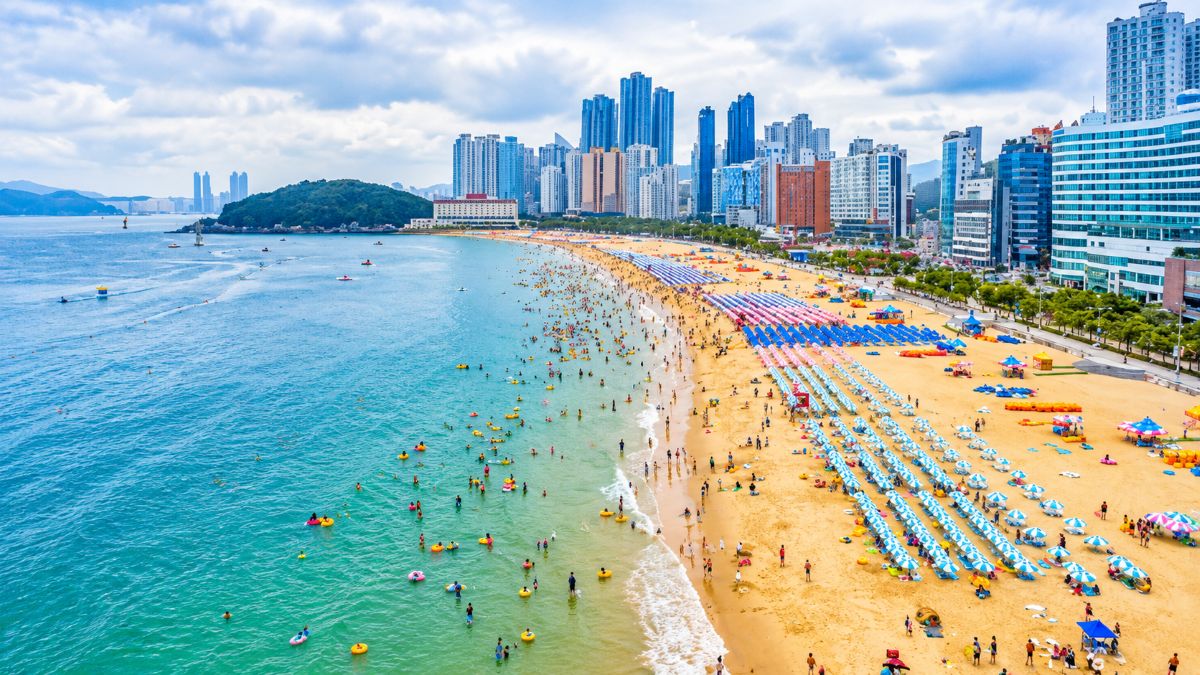 Haeundae beach in busan with golden sand, high-rise hotels, visitors and the coastline of south korea