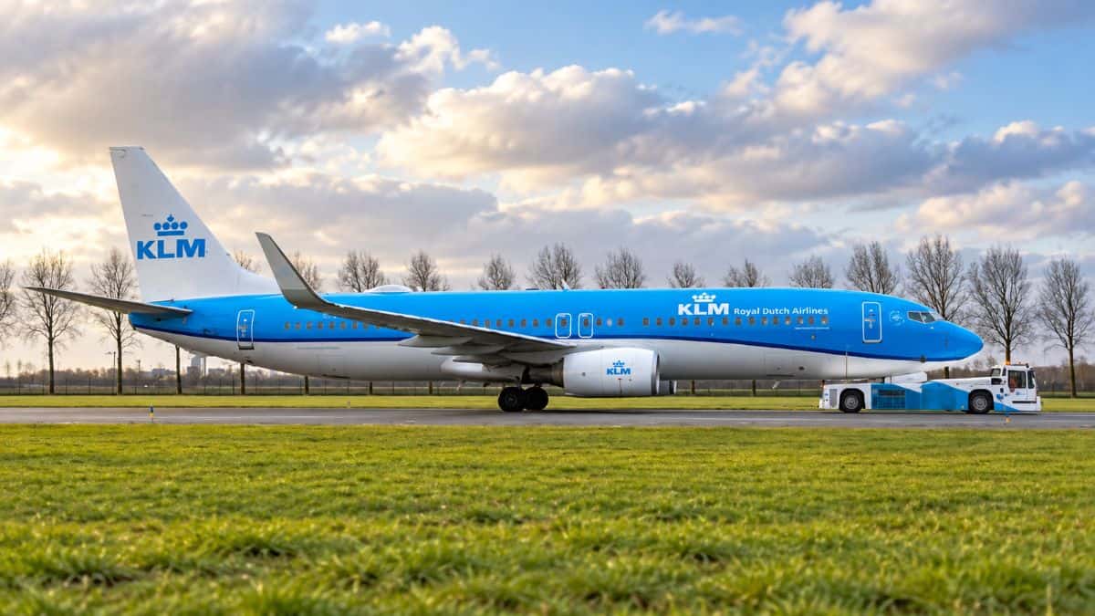 Klm aircraft preparing for departure at amsterdam schiphol airport during the winter travel season.