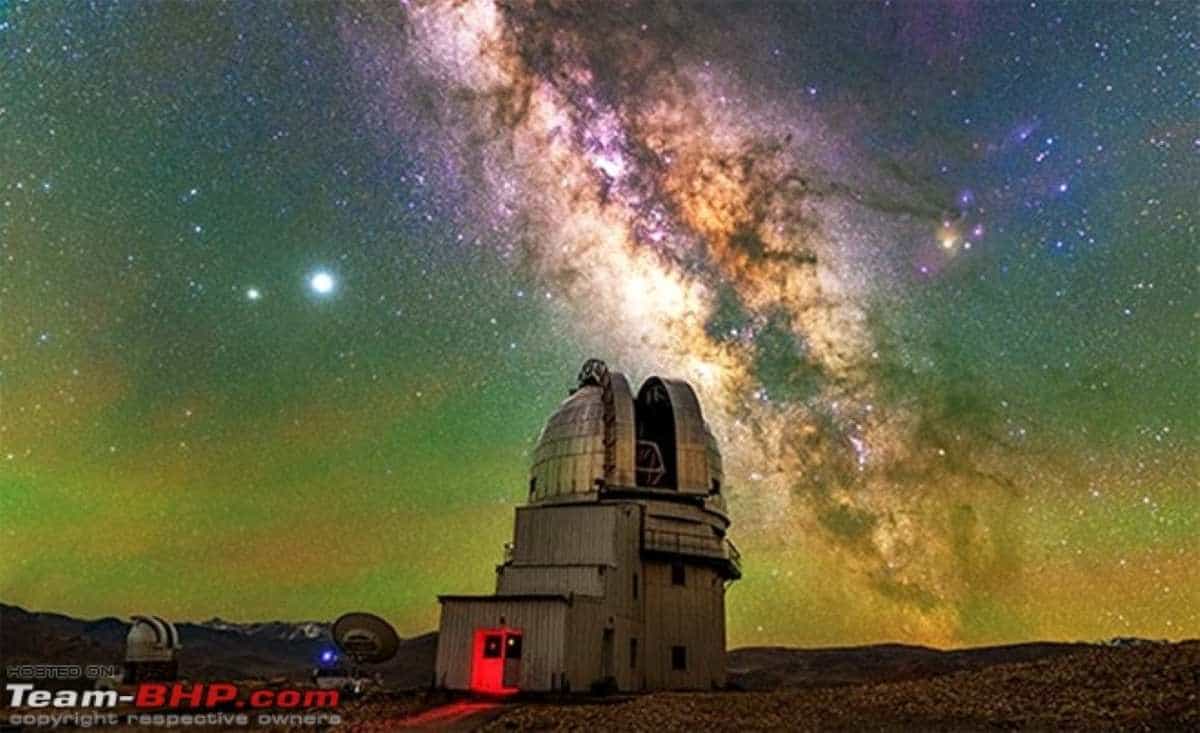 Ladakh - travel and tour world A breathtaking nighttime view of the milky way arching across the clear, star-studded sky above the rugged landscape and telescopes of the hanle observatory in ladakh.