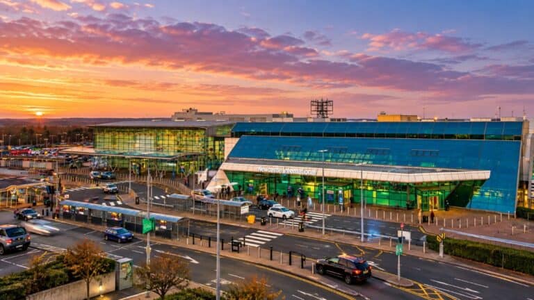 Newcastle International Airport terminal with aircraft preparing for departure amid reported flight delays caused by a technical issue.