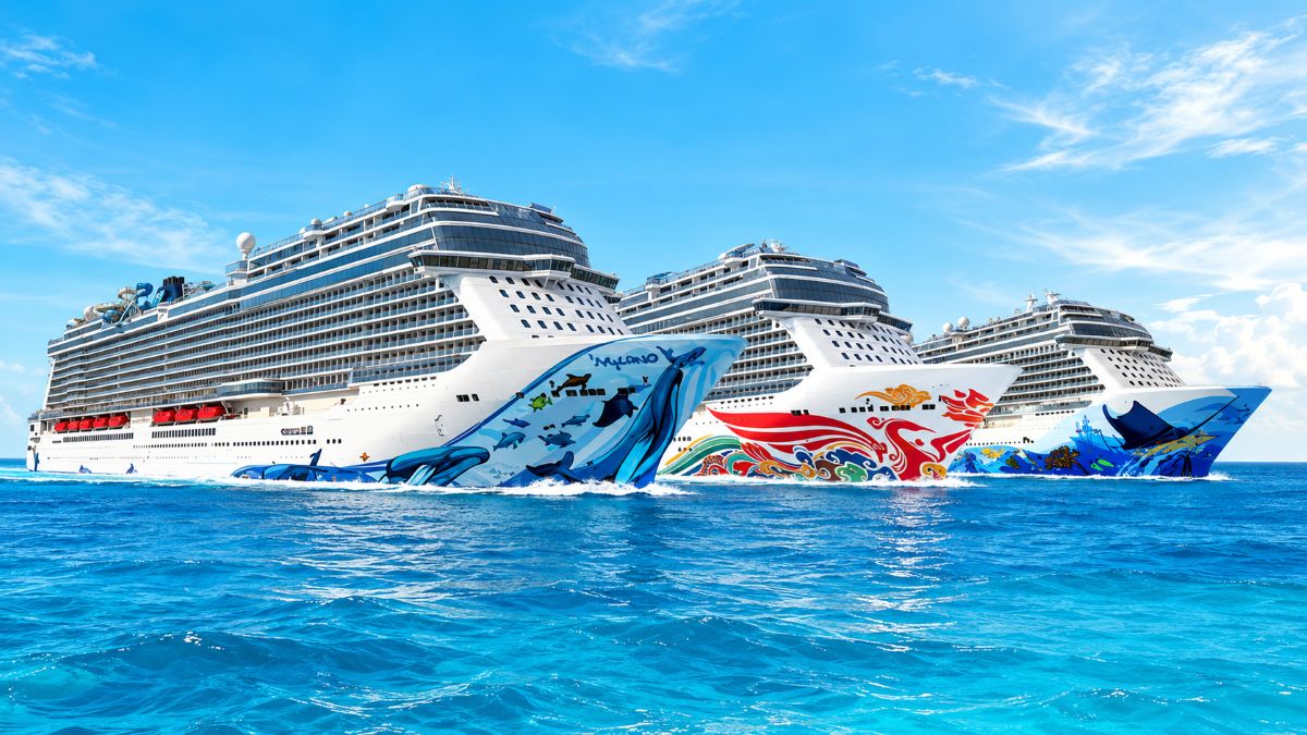 Norwegian jade cruise ship sailing towards japan during its far east deployment with a scenic coastal backdrop