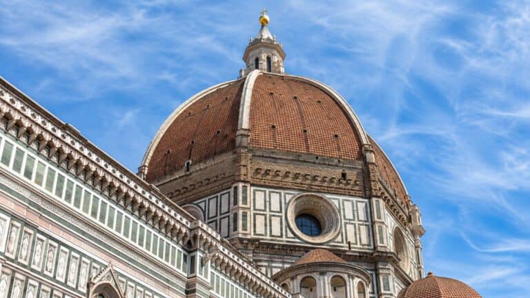 Ornate Italian historic building façade featuring intricate sgraffito architectural decoration and Renaissance-inspired motifs