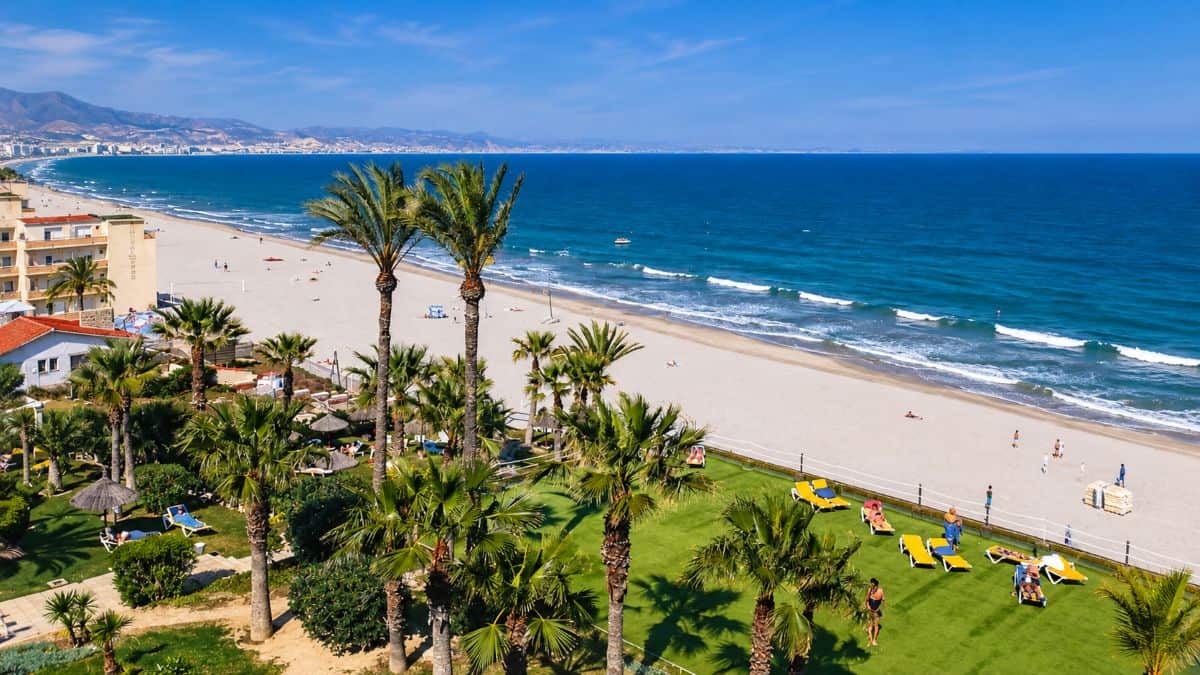 Scenic spanish island landscape featuring turquoise waters, golden beaches, volcanic terrain and mediterranean coastal scenery.