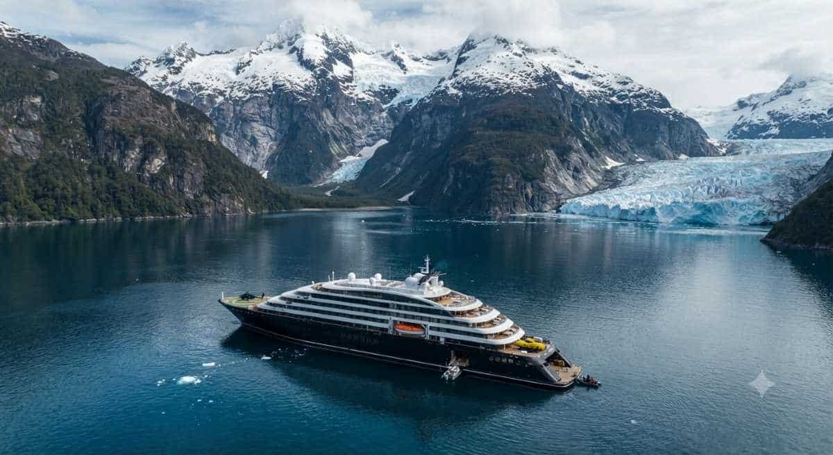 A sleek Scenic Discovery Yacht navigating the dramatic glacial fjords and coastal waters of Chile during an expedition cruise.