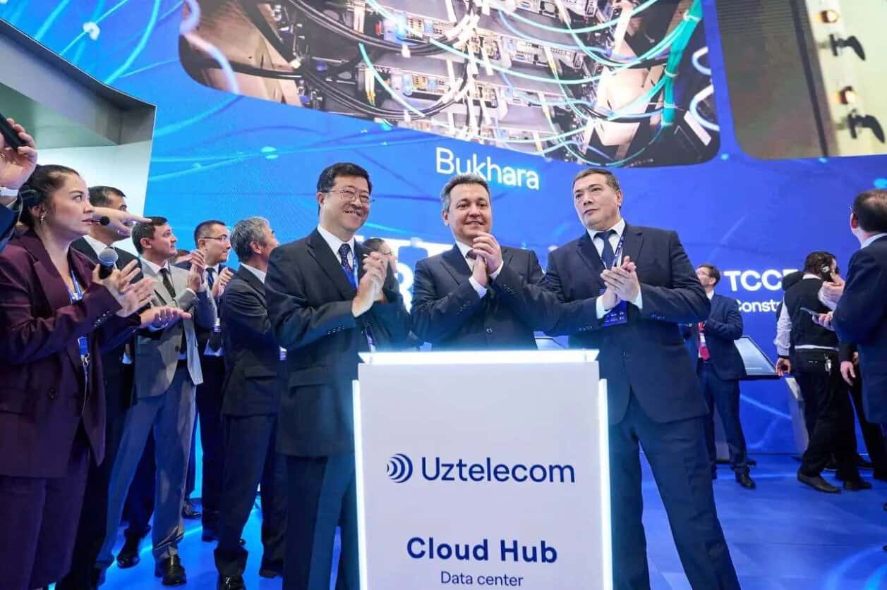 Officials at an ictweek 2026 exhibition stand in tashkent, uzbekistan.
