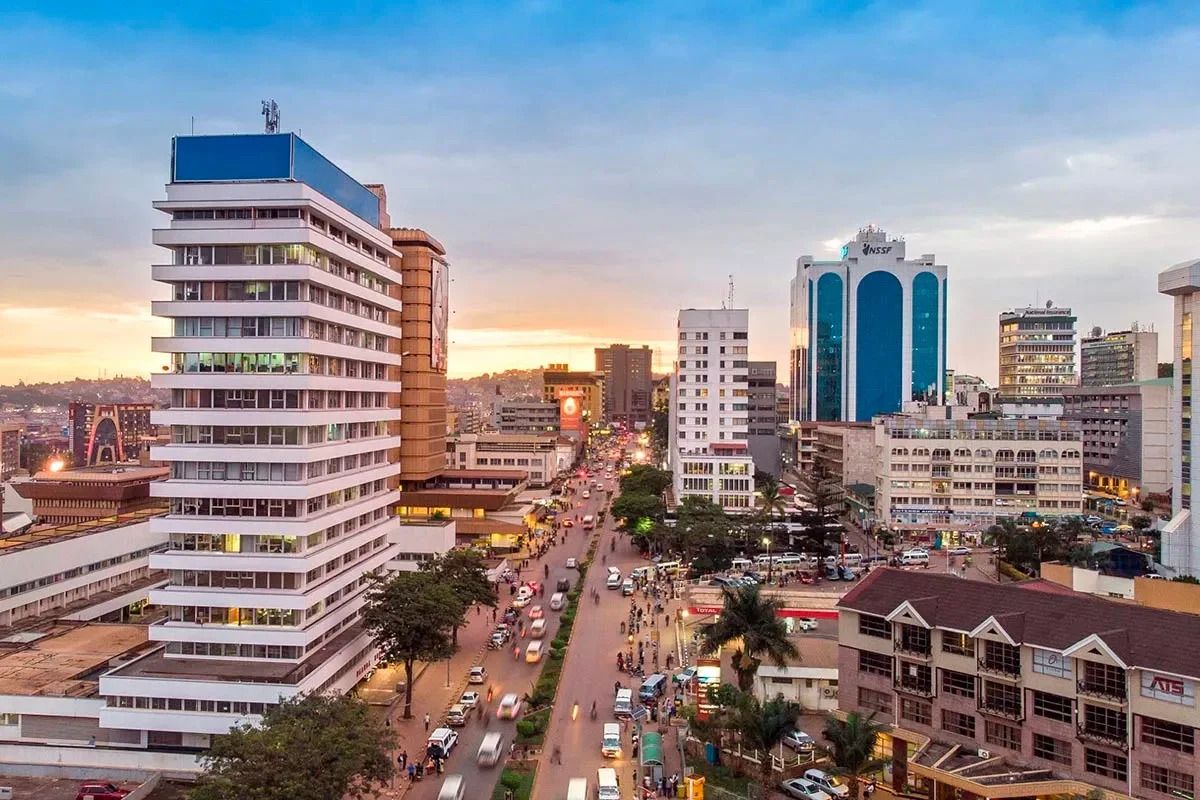 Aerial view of kampala city skyline at sunset, showcasing modern commercial buildings, busy streets with traffic, and urban development in uganda.