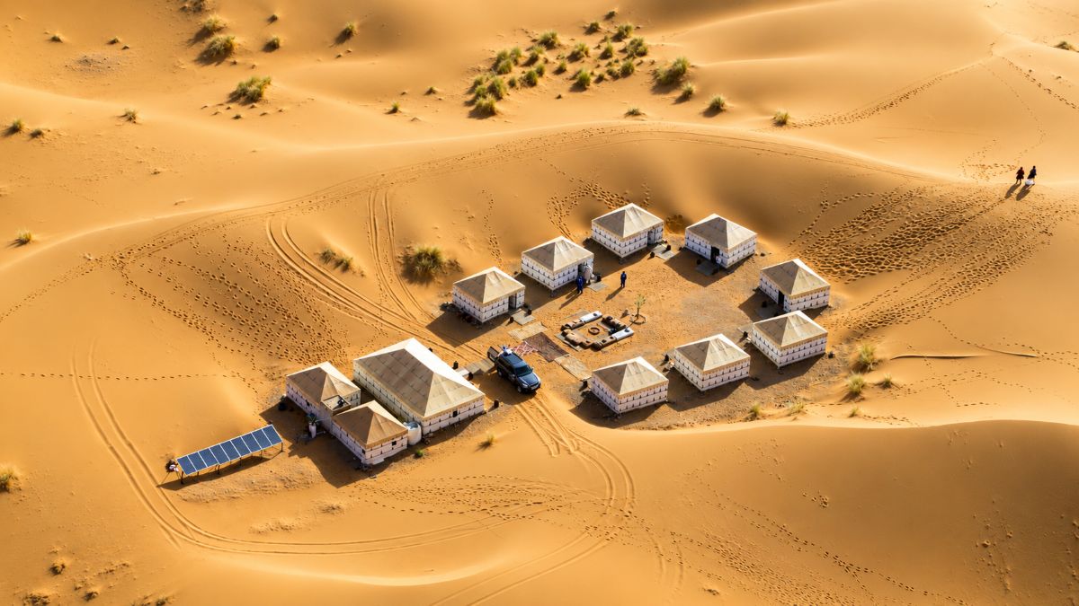 Ultra-realistic moroccan travel scene showing a glamorous coastal cityscape, modern transport connectivity and travellers enjoying morocco, representing resilient tourism demand.
