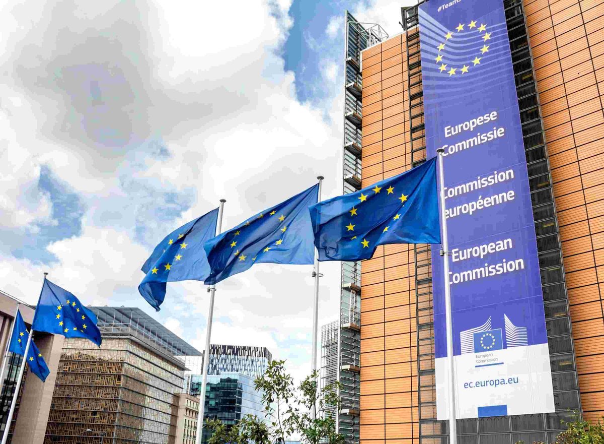 European union flags outside european commission building in brussels representing europe’s international cooperation and travel connections.