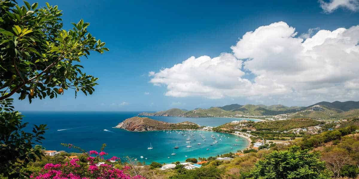 Turquoise bay with sailboats in antigua and barbuda