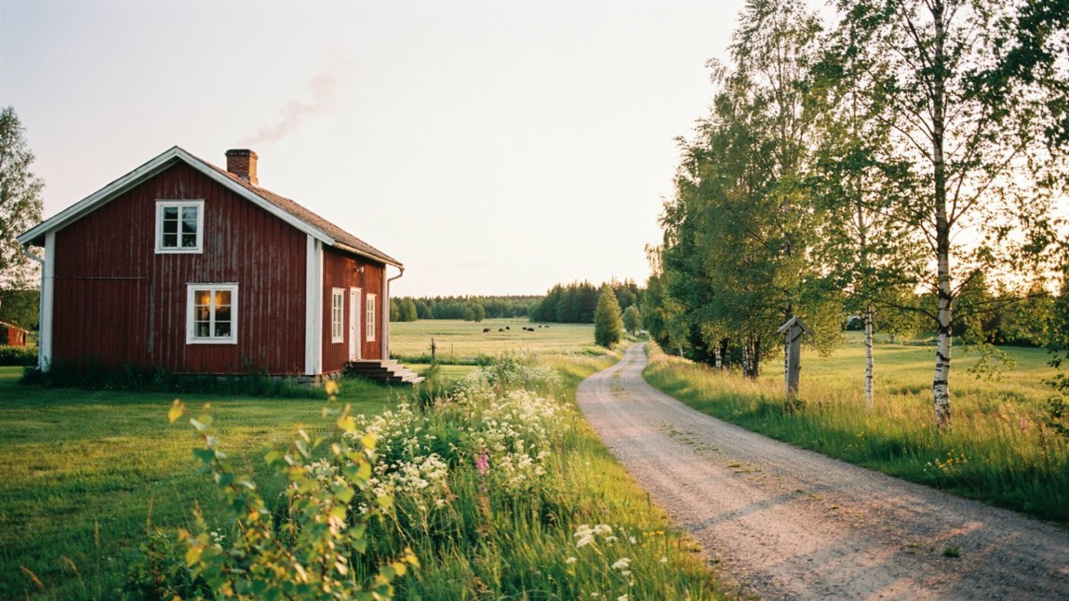 Red wooden cottage by road