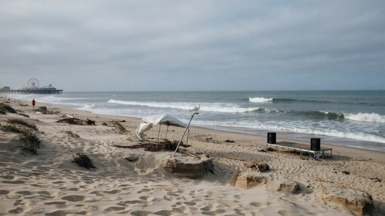 Storm-damaged santa monica coastline highlighting disruption to festival tourism and travel.