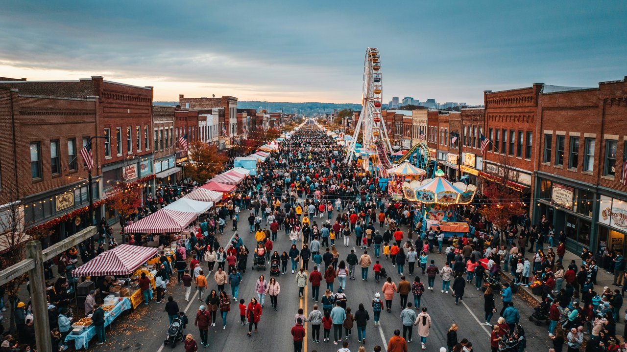 Crowds enjoying indiana&rsquo;s west side nut club fall festival with food stalls, rides and community celebrations in evansville