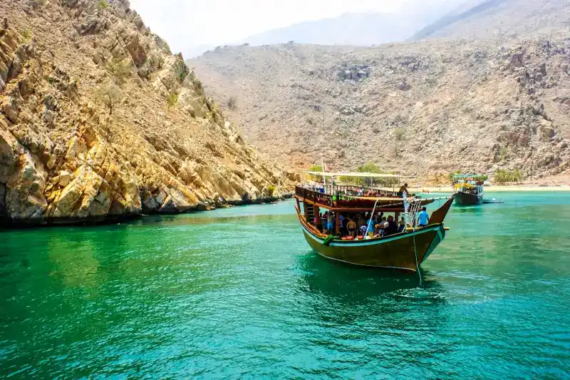 Boats sailing in musandam peninsula