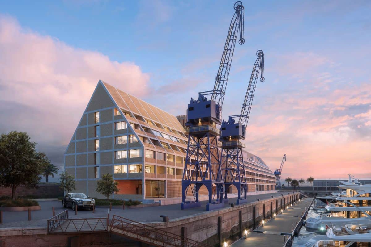 Cape town - travel and tour world Architectural 3d rendering of the quay 7 superyacht marina development at the v&a waterfront in cape town, south africa, featuring two historic blue industrial harbor cranes standing on a concrete quay beside luxury yachts moored at floating jetties. In the background, a modern pitched-roof hotel building stands against a soft pink and blue sunset sky.