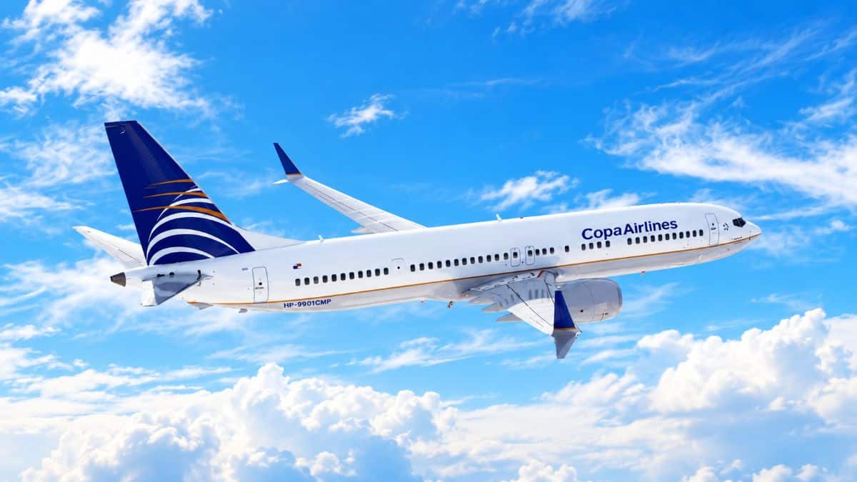 Copa airlines jet above the clouds - travel and tour world : copa airlines boeing 737-800 aircraft preparing for a holiday season flight connecting panama city with montreal and toronto in canada.