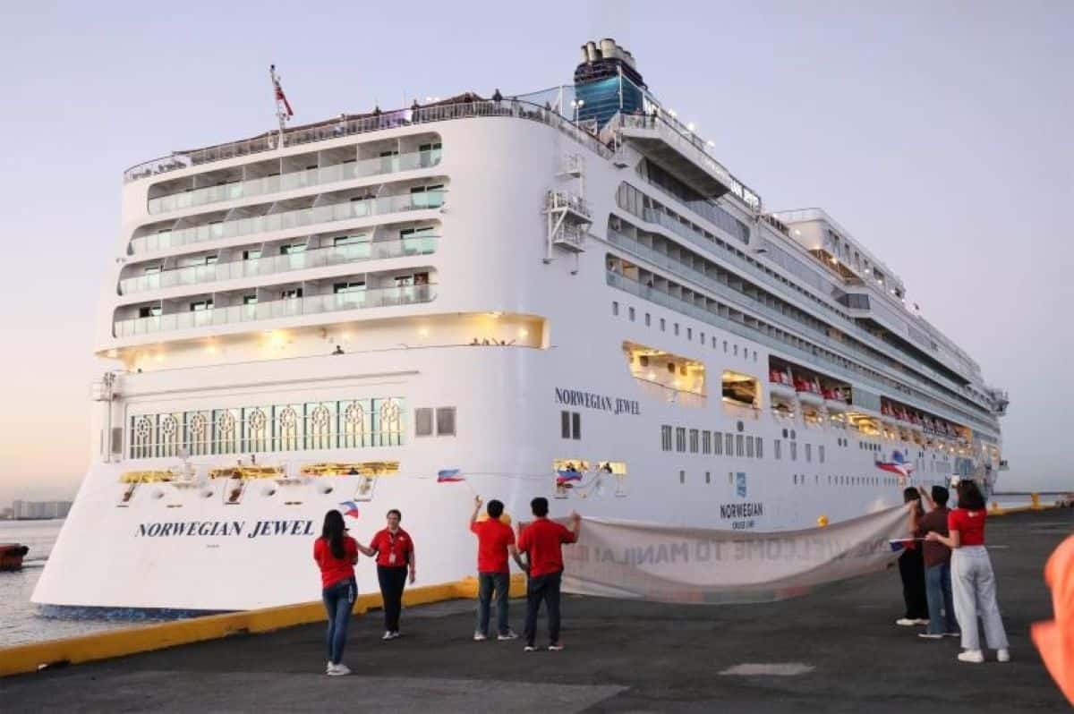 Cruise - travel and tour world Cruise ship at a southeast asian port with local tourism businesses and island destinations representing regional cruise tourism revenue.