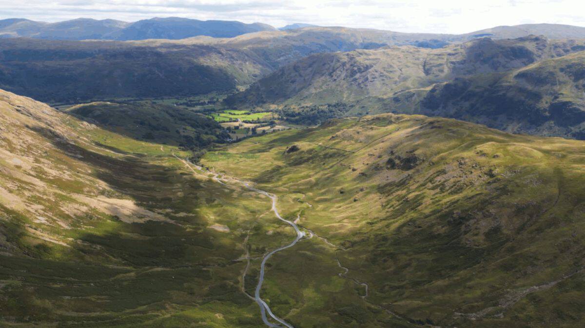 Cumbrian dark skies festival ignites autumn stargazing across lake district - travel and tour world Paddlers in open canoes on a calm lake district lake at night beneath a starlit sky during the cumbrian dark skies festival