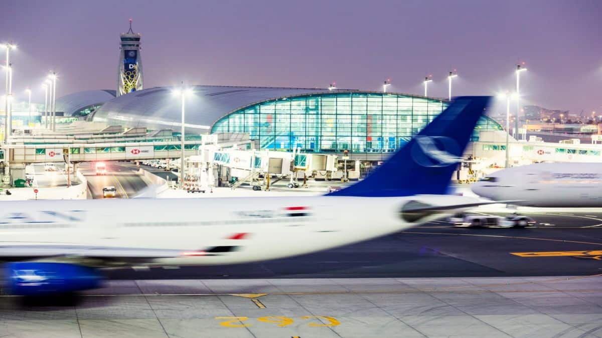 Dxb apron with the atc tower and concourse b in the background - travel and tour world Airports across the middle east face flight cancellations