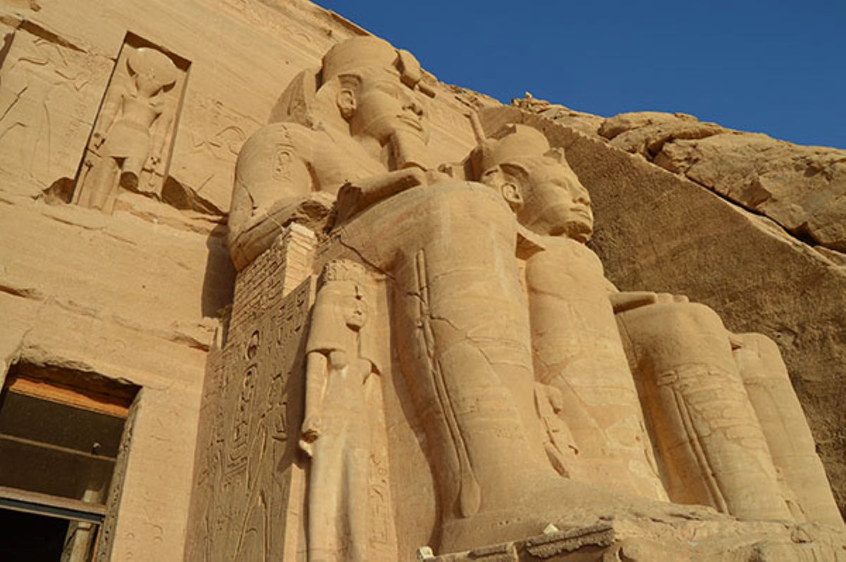 Egypt - travel and tour world Colossal rock-cut seated statues of ramesses ii carved into the sandstone façade of the abu simbel temples in southern egypt.