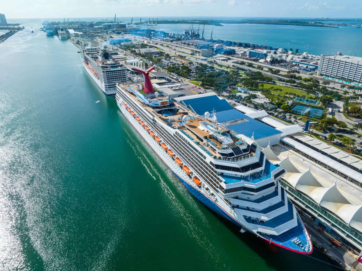 Florida cruise - travel and tour world Aerial view of carnival cruise ships docked at portmiami in florida, showing cruise terminals, waterfront facilities and turquoise harbour waters.