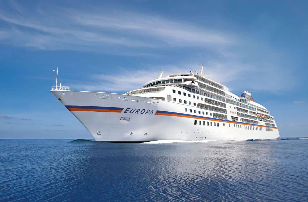 Ms europa cruise ship sailing across calm blue water, with its white hull and passenger decks in view.
