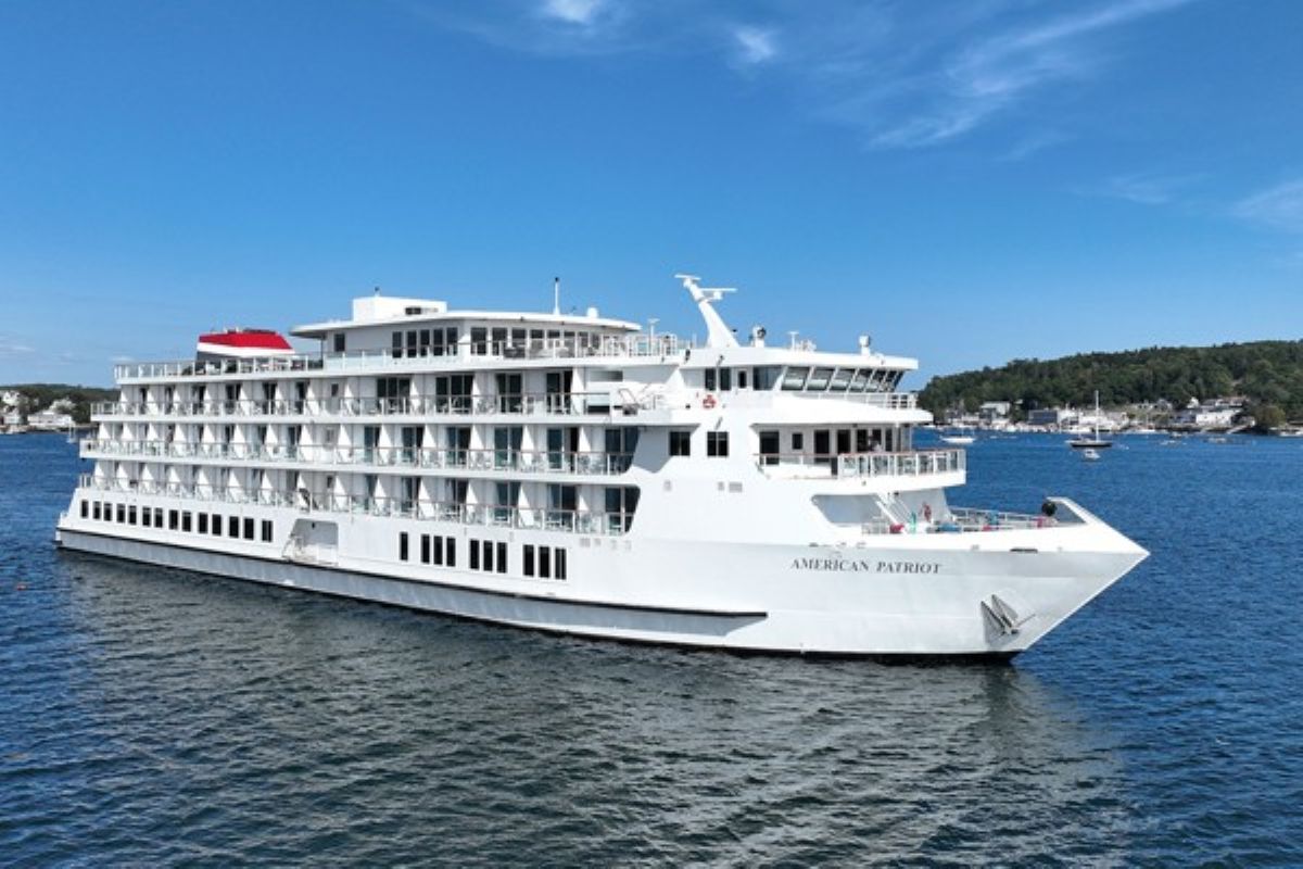 Boutique cruise ship transiting the great lakes waterways near historic locks and island harbours.